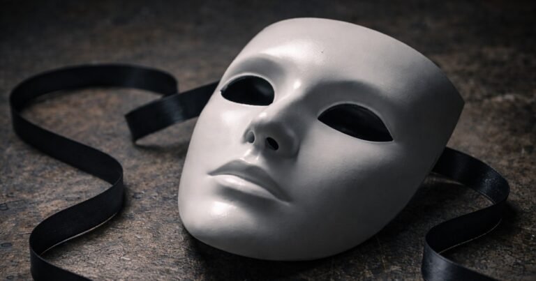 White mask symbolizing the narcissistic facade, hidden identity, and emotional emptiness.